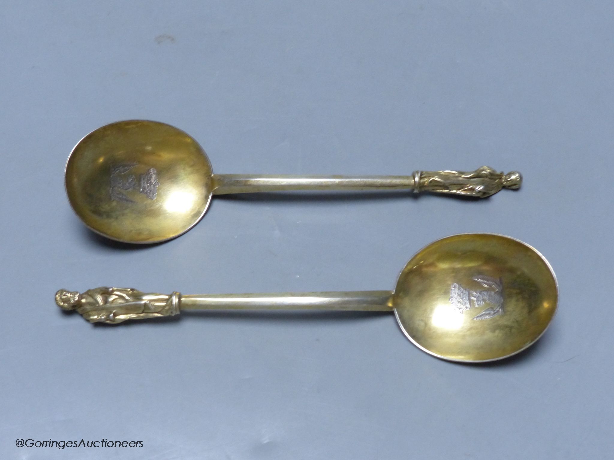 A pair of 19th century Hungarian? gilt white metal apostle spoons, 19.1cm, with engraved crests, 137 grams.